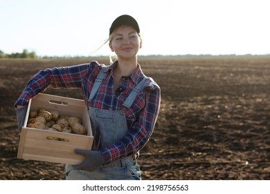 Happy smiling caucasian female potato farmer or gardener. Agriculture - food production, harvest concept - Powered by Shutterstock