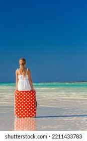 Happy Smiling Caucasian Girl With Red Polka Dot Travel Suitcase Enjoying Childhood On Her Tropical Beach Vacation Resort Bahamas