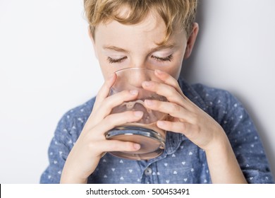 A Happy Smiling Child Drinking Chocolate Milk Isolated On White