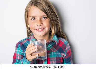 A Happy Smiling Child Drinking Chocolate Milk Isolated On White