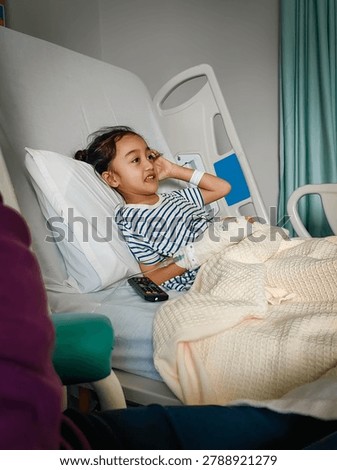 A happy, smiling child while being admitted to the hospital. Funny kid