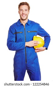 Happy Smiling Construction Worker In Blue Jumpsuit With Yellow Hardhat