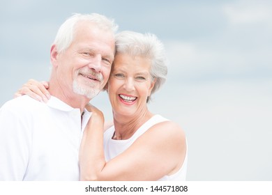 Happy and smiling couple in front of cloudy sky