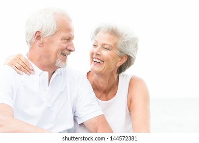 Happy and smiling couple in front of white sky