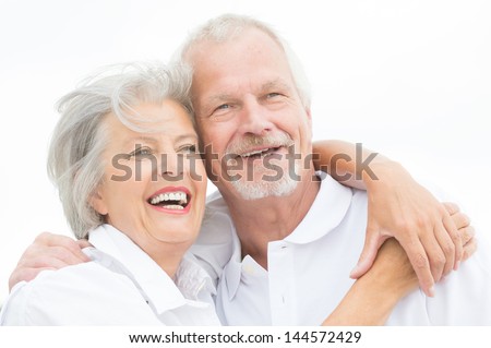 Happy and smiling couple in front of white sky