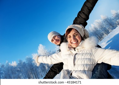 Happy Smiling Couple On A Winter Background