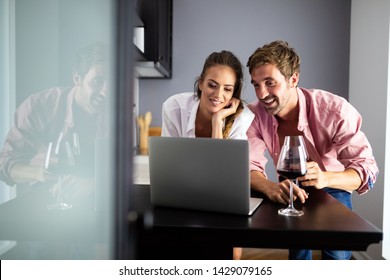 Happy smiling couple using laptop at home - Powered by Shutterstock