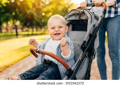 Happy smiling cute kid walking with mom outdoors on summer day