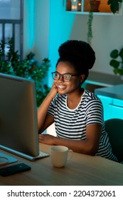 Happy Smiling Designer Girl Enjoy Working From Home On New Remote Project. Successful African Web Developer Coding New Program, Website Or Software. Young Freelance Black Woman On Distance Occupation