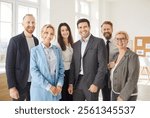 Happy smiling diverse professional business team standing in modern office, looking at camera, young and old teambuilding workers staff group together, human resource corporate portrait in office 