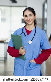 Happy smiling doctor woman holding clipboard at hospital, Professional doctor medical and healthcare.   - Shutterstock ID 2256857449