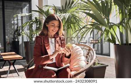 Similar – Image, Stock Photo Positive successful woman entrepreneur with Afro hair holds digital tablet, stands outdoor near office building, wears formal clothes, looks away, waits for colleague to have dinner during break