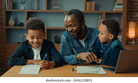 Happy smiling family e-learning home education African American father man private teacher with two boys kids children help little schoolboy son child boy with school homework teaching writing task - Powered by Shutterstock