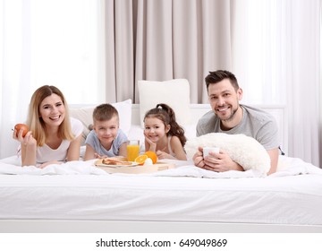 Happy smiling family having breakfast in bed - Shutterstock ID 649049869