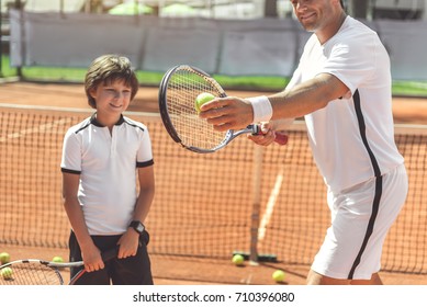 Happy smiling family playing tennis - Powered by Shutterstock