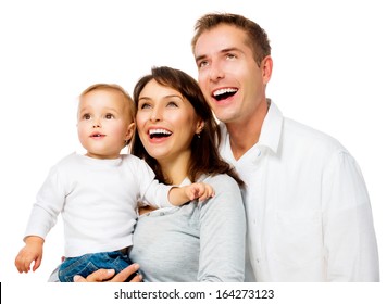 Happy Smiling Family Portrait isolated on White Background. Father and Mother with Little Baby Looking Up and Laughing. Parents with Child with Healthy White Teeth