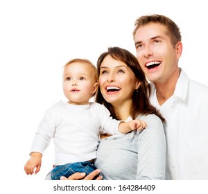 Happy Smiling Family Portrait Isolated On White Background. Father And Mother With Little Baby Looking Up And Laughing. Parents With Child With Healthy White Teeth