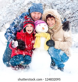 Happy Smiling Family With Snowman Winter Portrait