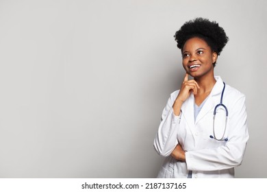 Happy Smiling Female Doctor Looking Up On White Studio Wall Banner Background