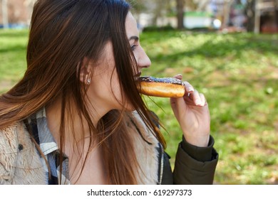 Happy Smiling Girl Eating A Donut
