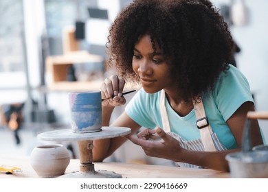 happy smiling girl having fun to learning and work with craft art of clay hand-made workshop in ceramic studio, little ceramist enjoy in creative handcraft hobby with pottery artisan school class - Powered by Shutterstock