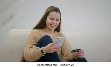 Happy Smiling Girl Shopping Online, Holding Card And Smartphone. E-banking App Service. Online Banking With Smart Phone.