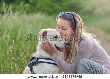 Happy smiling dog with its pretty young owner