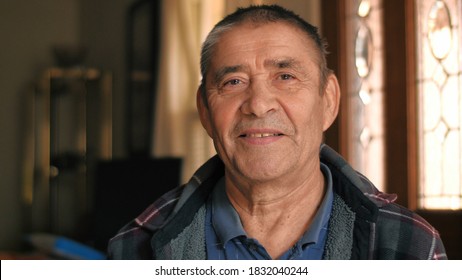 Happy smiling healthy young looking senior man portrait. Closeup, shallow DOF.