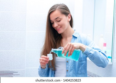 Happy Smiling Healthy Young Woman Using In Bathroom A Mouthwash Gel To Rinsing Mouth, Fresh Breath, Dental And Gums Health. Oral Hygiene And Teeth Care 