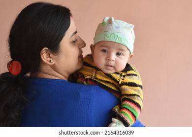 Happy smiling Indian ethnic woman mother hugging her little child boy. Healthcare and medical love Asia woman lifestyle mother's day concept . baby wearing winter dress.  