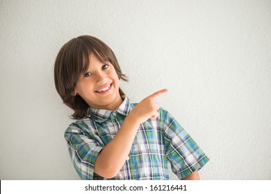 Happy Smiling Kid Pointing His Finger