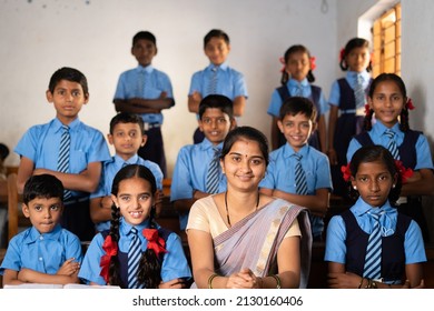 Happy Smiling Kid With Teacher Prepared For Class Group Photo Or Picture At Classroom By Looking At Camera - Concept Of Last Day Of School, Childhood Memories And Happiness