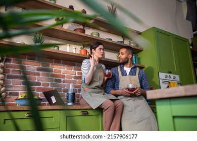 Happy And Smiling Large Woman Working On Her Laptop While Sitting Over The Kitchen Table In The Large Kitchen She Looking At The Window And Smile Large