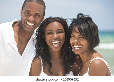 A happy smiling laughing African American family of father mother & daughter at the beach in the summer