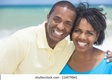 A Happy Smiling Laughing African American Man And Woman Couple At The Beach In The Summer