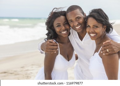 A Happy Smiling Laughing African American Family Of Father Mother & Daughter At The Beach In The Summer