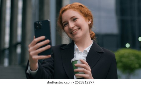 Happy smiling laughing gen z Caucasian girl woman female businesswoman blogger drinking coffee talking mobile phone video business call conversation webcam speak online connection outdoors city street - Powered by Shutterstock