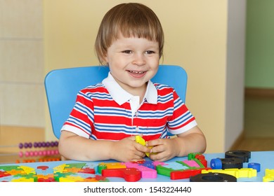 Happy smiling little baby boy playing with colorful puzzle. Concept of child development - Shutterstock ID 1543224440
