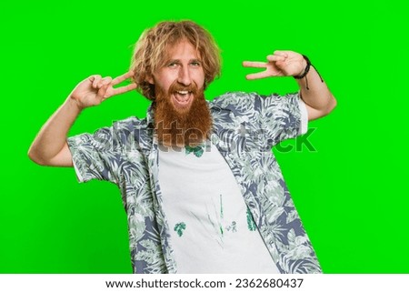 Happy smiling man listening music and dancing disco fooling around having fun expressive gesticulating hands relaxing on party making funny moves. Redhead bearded guy isolated on chroma key background