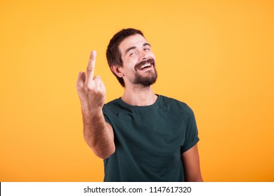 Happy smiling man showing his middle finger to the camera. Obscene gesture - Shutterstock ID 1147617320