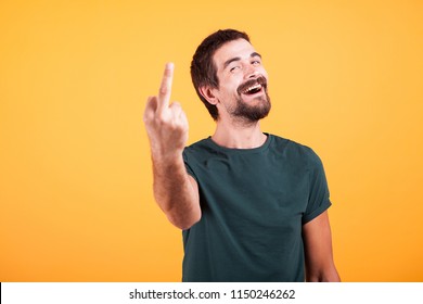Happy smiling man showing his middle finger to the camera. Obscene gesture - Shutterstock ID 1150246262