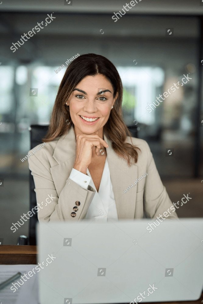 Smiling elegant confident middle aged woman standing in office, portrait.  Stock Photo by insta_photos
