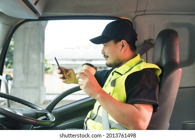 Happy Smiling Men Truck Driver Holding Cup Coffee Drink Parking, Relaxation During Driving Long Time. Young Asian Bearded Man Career Service, Transport And Delivery Find Location On Smartphone.