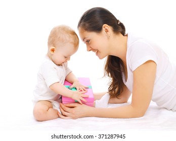 Happy Smiling Mother And Baby With Gift Box On A White Background