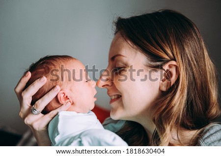 Similar – Image, Stock Photo Mother hugging her baby in front of fireplace