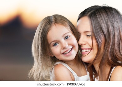 Happy Smiling Mother And Daughter Hugging