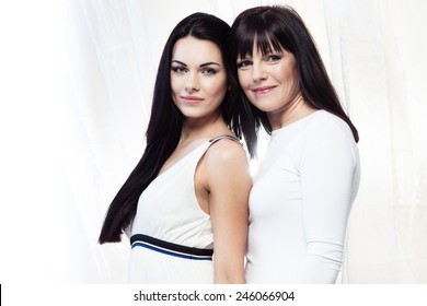 Happy Smiling Mother And Daughter On White Background