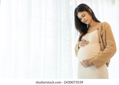 Happy smiling Mother woman hugging and smiling expecting with pregnancy hold baby in belly, woman pregnant, birth, preparation, maternity, care with childbirth at home.Love of family - Powered by Shutterstock