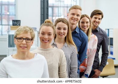 A Happy, Smiling Office Work Colleagues Team In An Ascending Order Style Portrait In A Bright Office Setting.