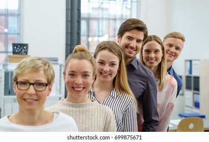 A Happy, Smiling Office Work Team In An Ascending Order Style Portrait In A Bright Office Setting.